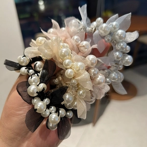 Detail of multi-color mesh scrunchies with pearls and camelias for hairstyles
