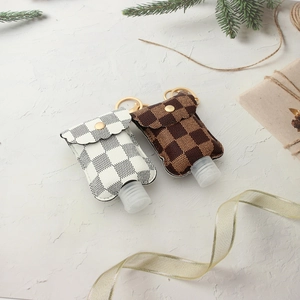 Portable PU leather hand sanitizer holder with checkerboard pattern and gold keychain