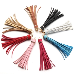 Close-up of 8 colorful PU leather tassels with gold metal caps in a radial layout