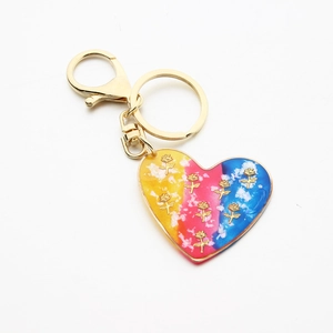 Detail of gradient resin heart keychain with gold roses and metallic lobster clasp