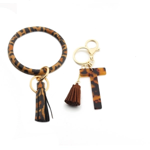 Detailed leopard print PU leather wristlet set with acrylic T letter and double tassels