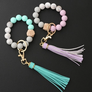 Silicone bead keychain bracelet with wooden bead and leather tassel in mint and pink