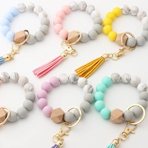 Close-up of silicone beads with wooden hexagon bead and leather tassel keychain