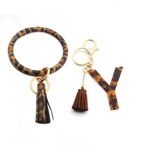 Close-up of leopard print PU leather keychain bracelet with acrylic letter Y and tassels