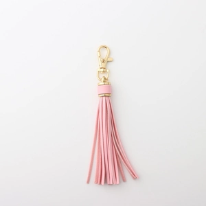 Pink leather tassel keychain with gold lobster clasp and elegant metal hardware