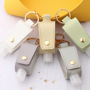 Set of five colorful PU leather hand sanitizer bottle holders with gold metal keyrings