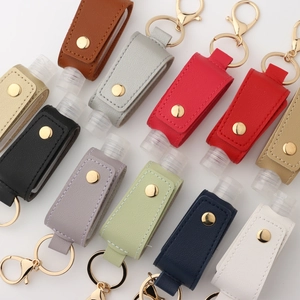 Portable PU leather travel bottle keychain set in multiple colors with metal lobster clasps
