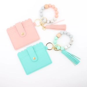 Detail of pink and mint silicone bead wristlet with PU leather tassel card holder
