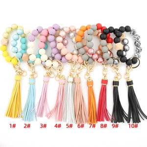 Collection of ten printed wooden bead wristlet keychains with elegant PU leather tassels