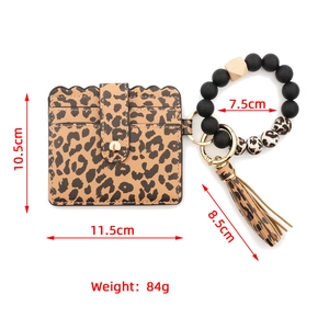 Detail view of leopard print card holder set with beaded bracelet and long tassel
