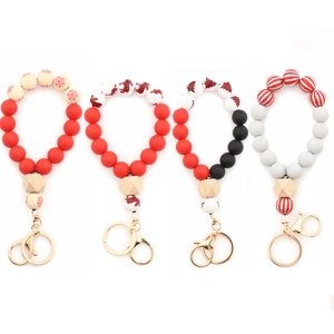 Set of four Christmas silicone bead wristlet keychains with wooden beads and festive patterns