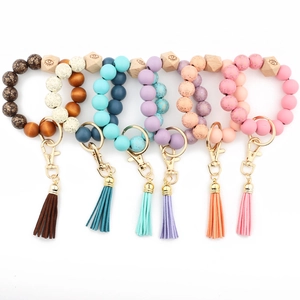 Flat lay of colorful beaded wristlet keychains with leather tassels and wood beads