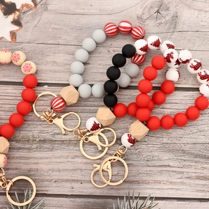 Christmas wristlet keychain with silicone and wood beads featuring festive holiday patterns