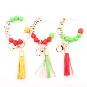 Detailed view of Christmas silicone bead bracelets with leather tassels and festive charms