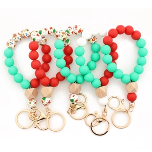 Cinq modèles de porte-clés de Noël en perles de silicone avec motifs Père Noël