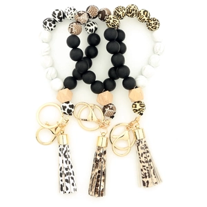 Porte-clés bracelet en perles de silicone avec perle en bois et pompon en cuir imprimé