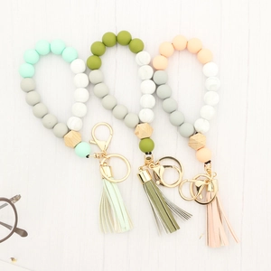 Silicone and beech wood bead keychain bracelet with leather tassel and gold metal ring
