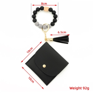 Detailed view of silicone bead wristlet with dimensions of wallet and tassel charm