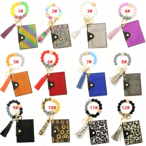 Macro display of 12 colorful silicone bead bracelets with diamond purses and leopard prints