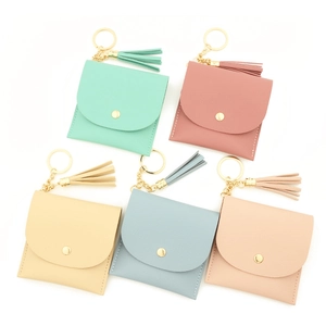 Detailed top view of multi-color leather card wallets with tassels and gold keyrings