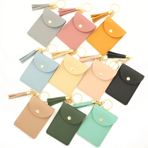 Flat lay of colorful PU leather tassel key ring card holders with metallic snap closure