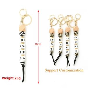Detail view of silicone bead keychains with wooden charms and leopard print accents