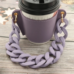 Close-up of purple PU leather coffee cup sleeve with matte plastic link chain handle