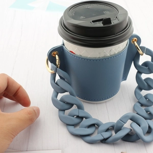 Macro view of blue leather coffee cup holder with matching acrylic chain strap