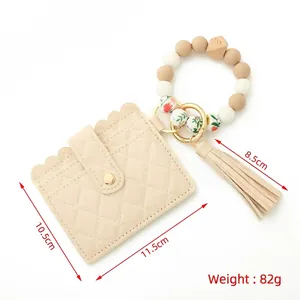 Beige quilted leather card holder wristlet with colorful silicone beads and tassel keychain
