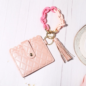 Pink quilted PU leather card holder with acrylic chain handle and tassel details