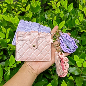 Quilted PU leather card holders with wavy edges, chunky chains and long tassels in pastel tones