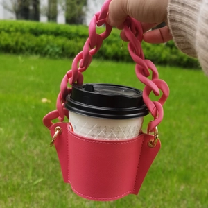 Hot pink leather coffee cup sleeve with thick macaron plastic chain handle and gold D-rings