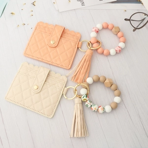 Quilted leather card holder with silicone bead bracelet and tassel in pink and cream