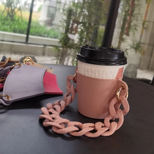 Pink leather coffee cup sleeve with thick matte macaron plastic chain handle detail