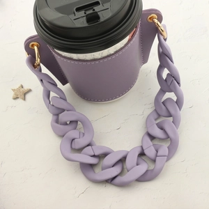 Detail of purple PU leather coffee cup sleeve with chunky plastic chain strap