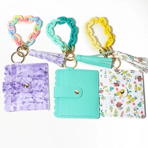 Detail view of floral and solid macaron card holders with resin chains and tassels