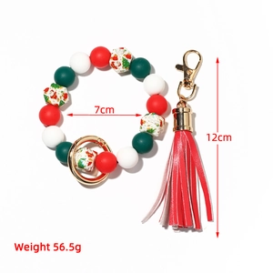 Macro view of Christmas silicone bead keychain with red tassel and holiday prints