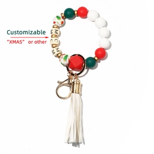 Detail of Christmas silicone bead bracelet with wooden letter beads and white tassel