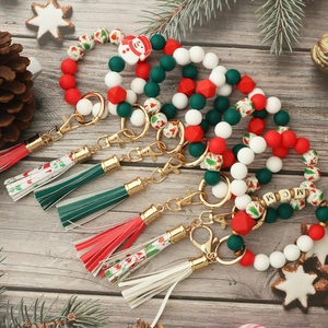 Detailed view of Christmas silicone bead keychain with festive tassels and gold clasp