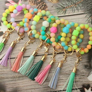 Variety of colorful luminous silicone bead wristlet keychains with elegant gold hardware