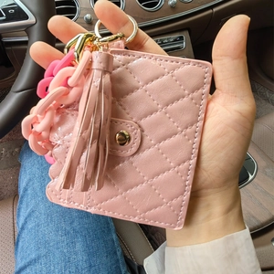 Pink quilted faux leather card holder with matching tassel and acrylic chain keychain