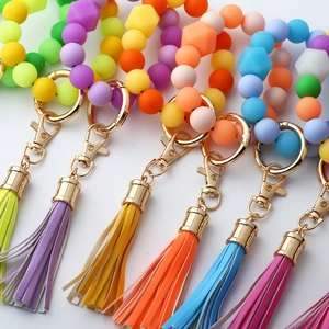 Detailed view of colorful silicone bead keyrings with PU tassels and gold metal clasps