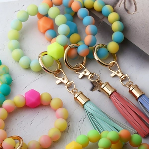 Glow-in-the-dark silicone bead keychain bracelet with leather tassel and gold ring clasp