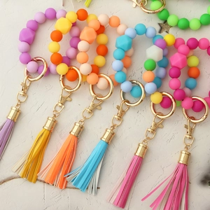 Luminous silicone bead keychain bracelets with leather tassels in vibrant assorted colors