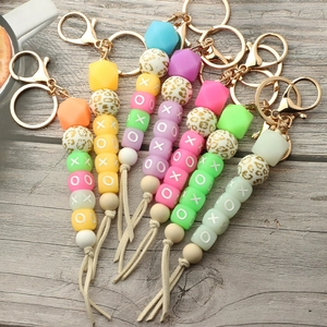 Luminous silicone bead wristlet keychain with XOXO charm and leather tassel pendants