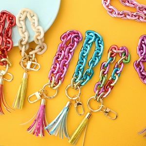Colorful acrylic chain link keychains with metallic gold rings and vibrant tassels