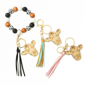 Cow print silicone beaded keychain bracelet with leather tassels and cow pattern wood charm