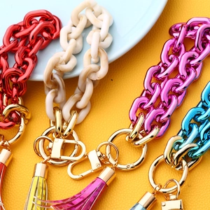 Detail of colorful acrylic chain keychain with vibrant tassels and gold lobster clasp