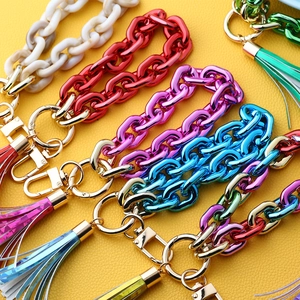 Colorful acrylic chain keychain with golden ring and holographic foil tassel detail