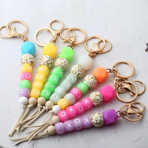 Detail of colorful silicone beaded keychain with leopard print, XOXO beads and leather tassel